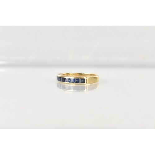 16 - A Sapphire Mounted 9ct Gold Half Eternity Ring, Channel Set Square Cut Stones in a Rectangular Reces... 