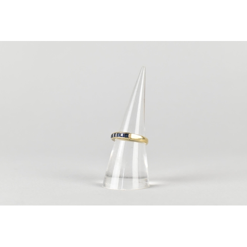 16 - A Sapphire Mounted 9ct Gold Half Eternity Ring, Channel Set Square Cut Stones in a Rectangular Reces... 