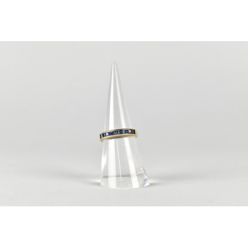 16 - A Sapphire Mounted 9ct Gold Half Eternity Ring, Channel Set Square Cut Stones in a Rectangular Reces... 