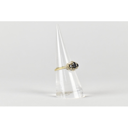 17 - A 9ct Gold, Sapphire and Diamond Cluster Ring, Primary Oval Cut Sapphire Measuring 5.2mm by 3.5mm, S... 