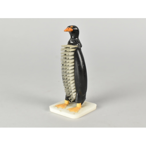 31 - A Mid 20th Century novelty plastic nail brush in the form a Penguin, Made in Hong Kong, 11cm high