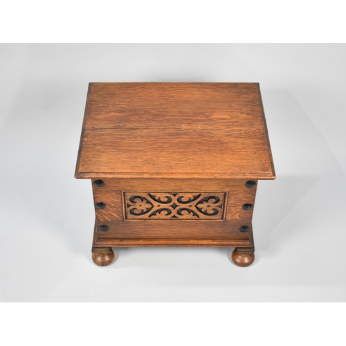 59 - An Edwardian Oak Box with carved front panel and hinged lid, 51cm wide and 41cm high