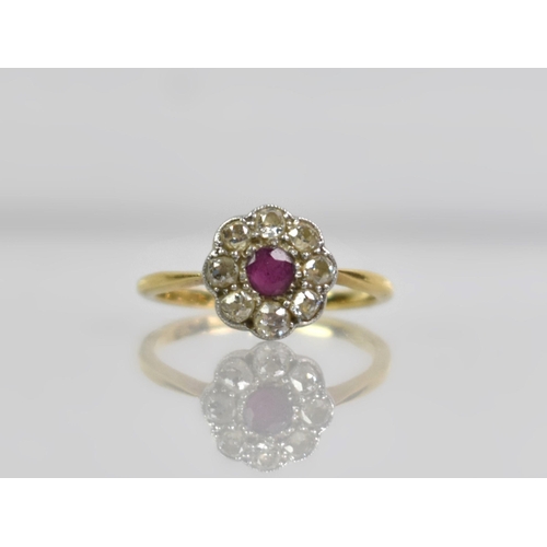 24 - An 18ct Gold, Platinum, Ruby and Diamond Daisy Ring, Old European Cut Ruby Measuring 3.1mm by 3.5mm ... 