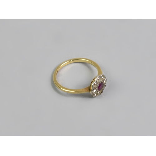 24 - An 18ct Gold, Platinum, Ruby and Diamond Daisy Ring, Old European Cut Ruby Measuring 3.1mm by 3.5mm ... 
