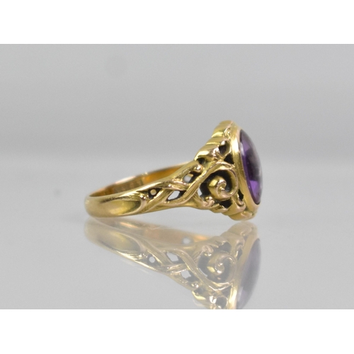 25 - An 14ct Gold and Amethyst Dress Ring, Oval Low Cabochon Stone, (Verso Faceted), Measuring 8.9x6.8mm.... 