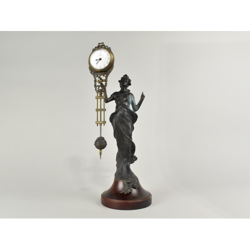 62 - A Reproduction Bronze Effect Art Nouveau Style Mystery Clock, 34cms High