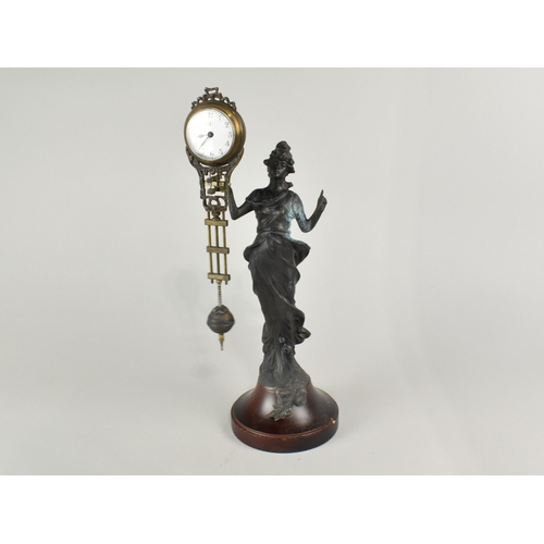 62 - A Reproduction Bronze Effect Art Nouveau Style Mystery Clock, 34cms High