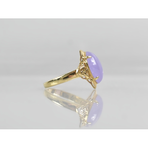 28 - A 14ct Gold and Lavender Jade Dress Ring, Central Oval Cabochon Stone Measuring 10.4mm by 15.1mm Sup... 