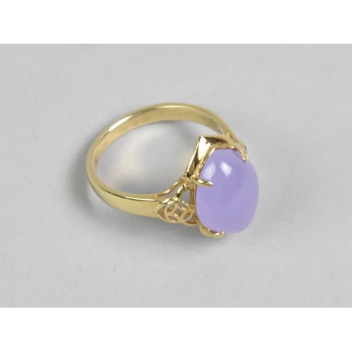 28 - A 14ct Gold and Lavender Jade Dress Ring, Central Oval Cabochon Stone Measuring 10.4mm by 15.1mm Sup... 