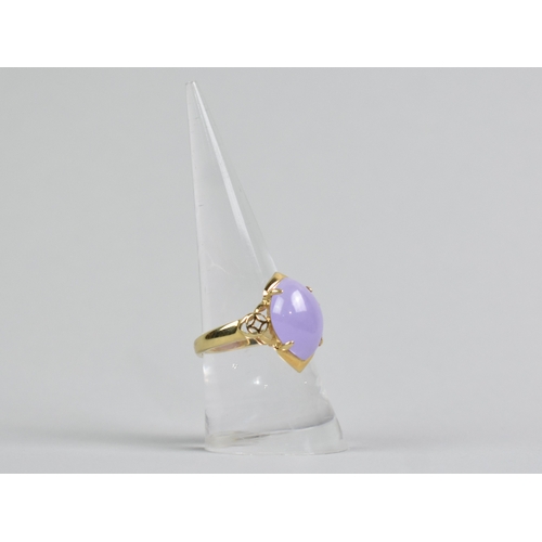 28 - A 14ct Gold and Lavender Jade Dress Ring, Central Oval Cabochon Stone Measuring 10.4mm by 15.1mm Sup... 