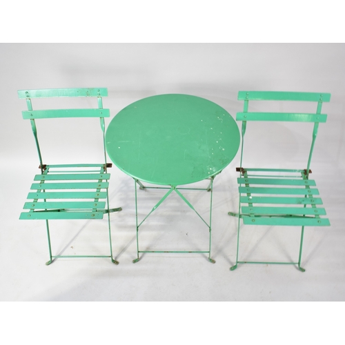 555 - A Mid 20th Century Green Painted Metal Folding Patio Table and Chair Set, Table 59cms Diameter