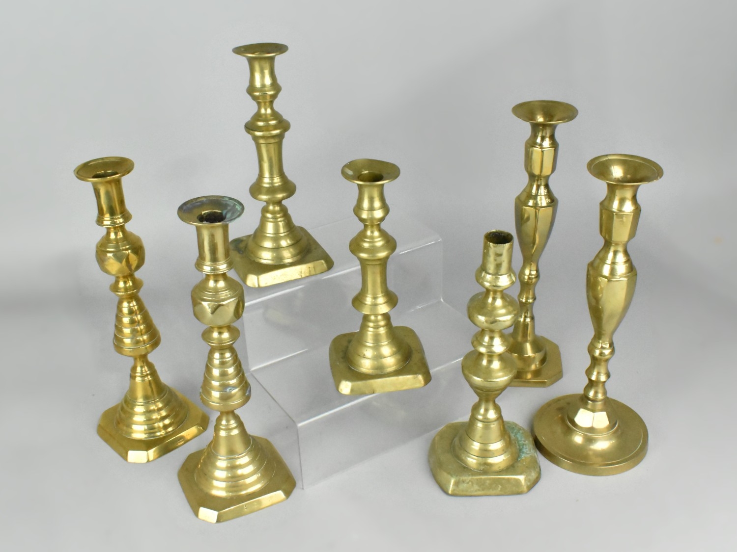 A Collection of Various Brass Candlesticks