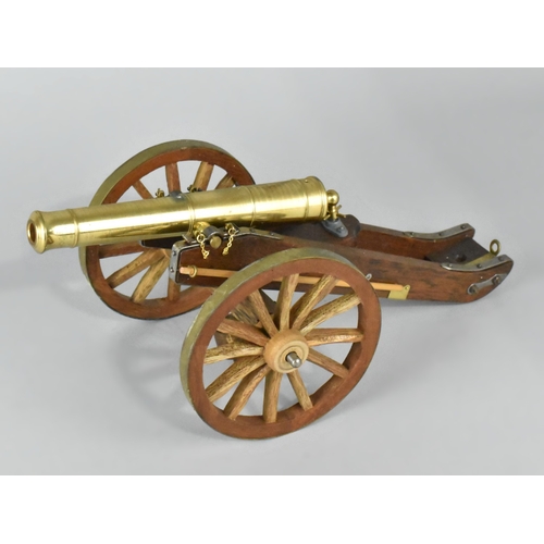 23 - A Brass and Wooden Model of a Napoleonic Field Cannon, 30cms Long