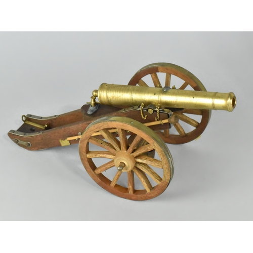 23 - A Brass and Wooden Model of a Napoleonic Field Cannon, 30cms Long