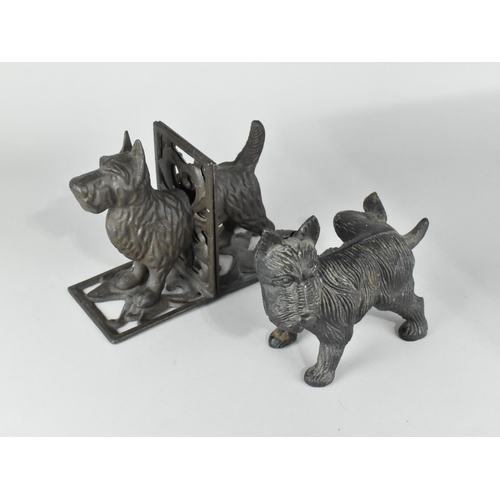 128 - A Cast Iron Door Stop in the Form of a Terrier with Cocked Leg together with a Pair of Bookends Deco... 
