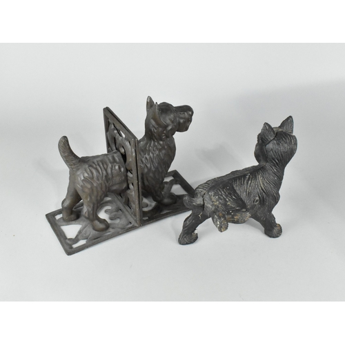 128 - A Cast Iron Door Stop in the Form of a Terrier with Cocked Leg together with a Pair of Bookends Deco... 