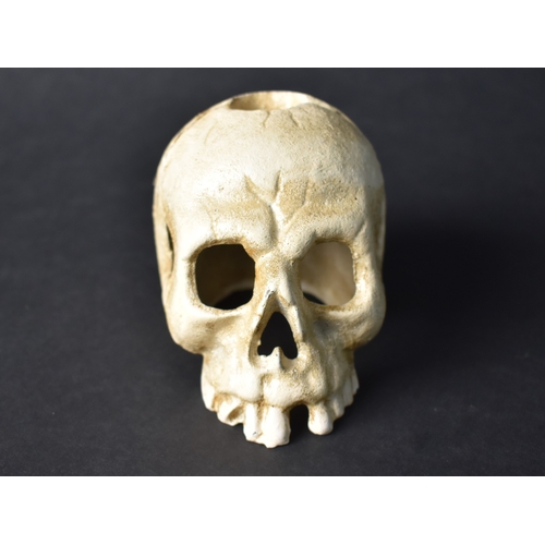 30 - A Cold Painted Cast Metal Novelty Candle Holder in the Form of a Small Human Skull, 7.5cms High