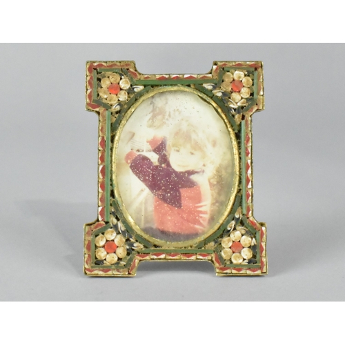 37 - A Small Enamelled Easel Back Photo Frame with Floral Decoration, 5.25cms Wide and 6.5cms High