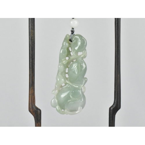 29 - A Chinese Jade Effect Pendant in Carved Wooden Arched Stand, 18.5cms High