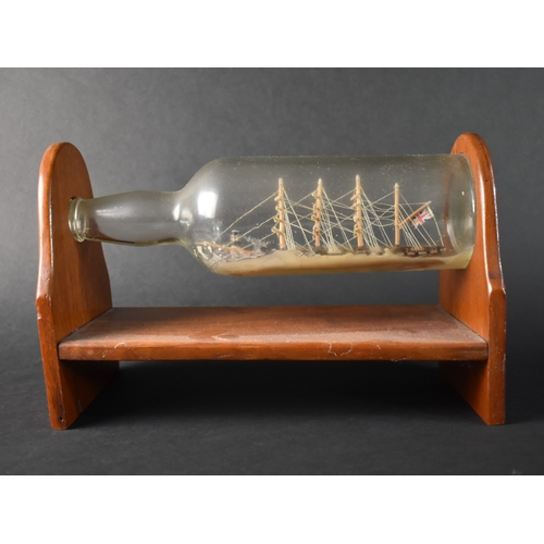 60 - A Mid 20th Century Ship in a Bottle Mounted on Wooden Stand, 28cms Wide