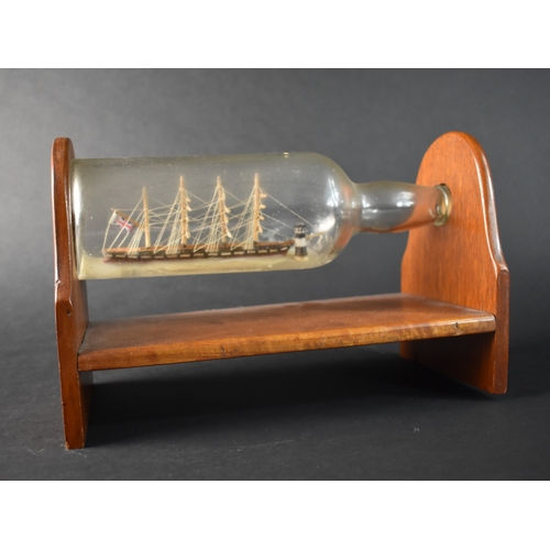 60 - A Mid 20th Century Ship in a Bottle Mounted on Wooden Stand, 28cms Wide