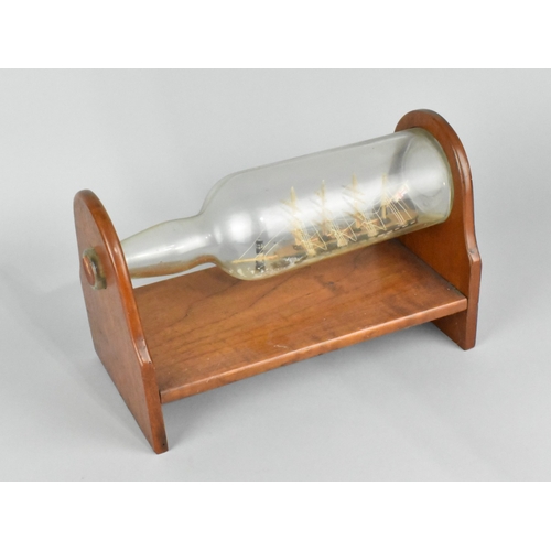 60 - A Mid 20th Century Ship in a Bottle Mounted on Wooden Stand, 28cms Wide