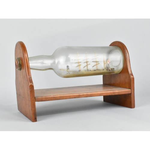 60 - A Mid 20th Century Ship in a Bottle Mounted on Wooden Stand, 28cms Wide