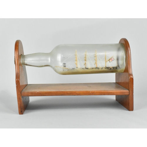 60 - A Mid 20th Century Ship in a Bottle Mounted on Wooden Stand, 28cms Wide