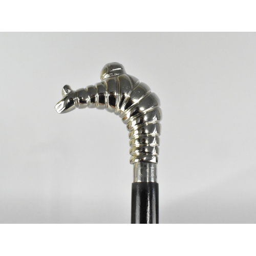 212 - An Ebonised Walking Cane with Michelin Man Handle