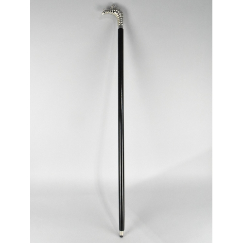 212 - An Ebonised Walking Cane with Michelin Man Handle