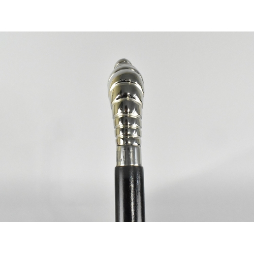 212 - An Ebonised Walking Cane with Michelin Man Handle