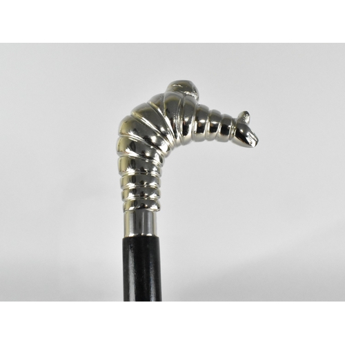 212 - An Ebonised Walking Cane with Michelin Man Handle