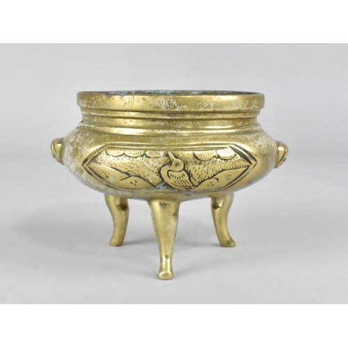 64 - A Chinese Polished Bronze Three Legged Censer, 10cms Diameter and 7.5cms High