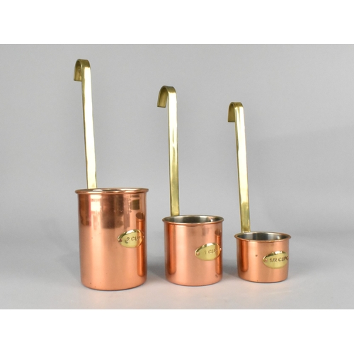7 - A Set of Three Copper and Brass Graduated Measures