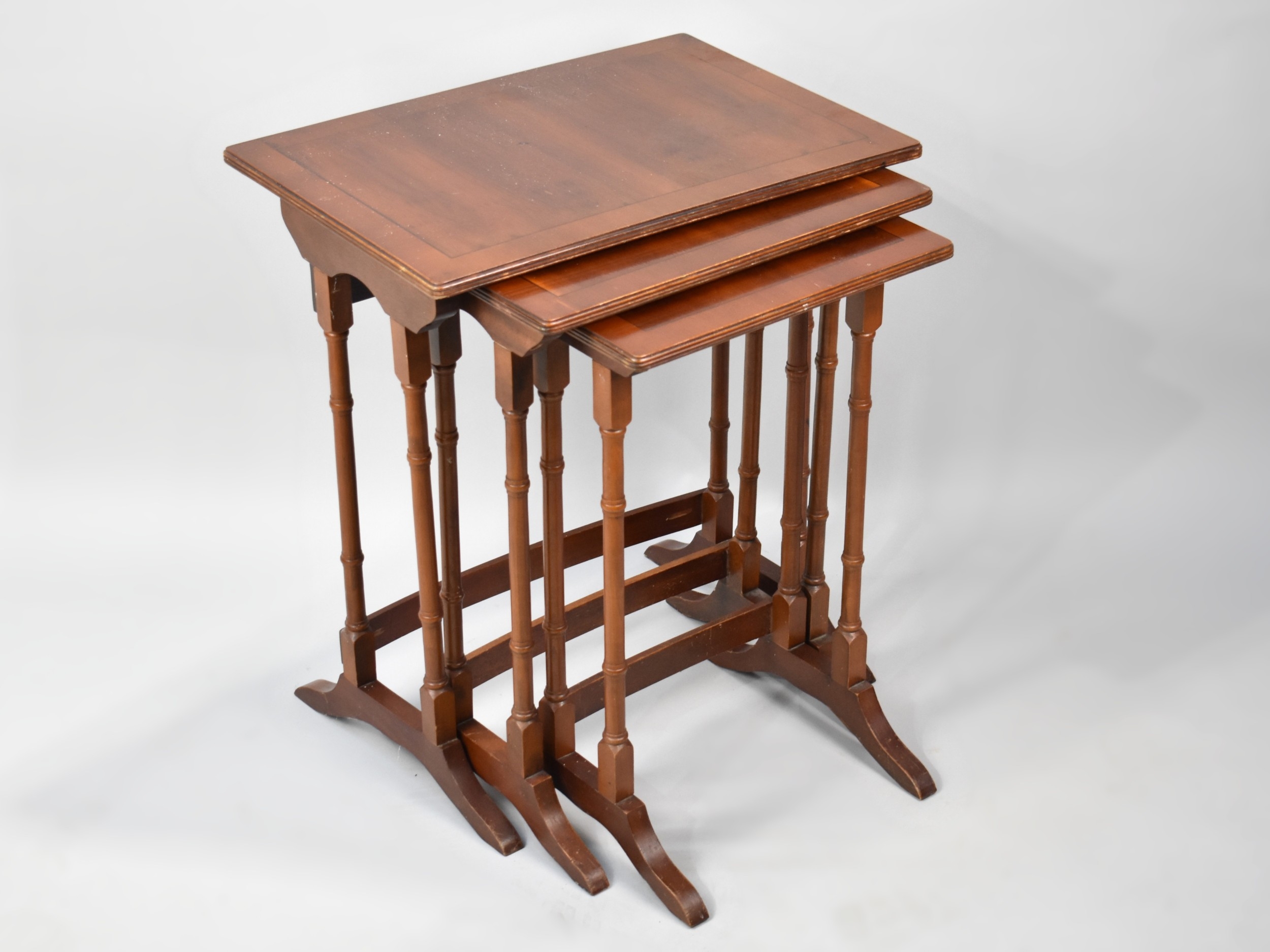 A Cross Banded Nest of Three Mahogany Tables, 49cms Wide