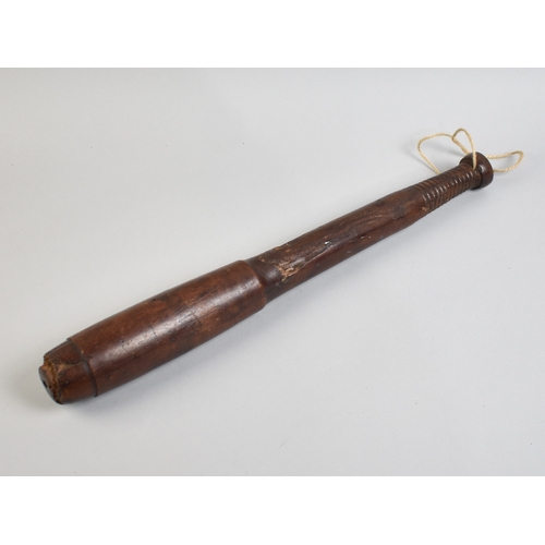 A Large and Long Turned Wooden Truncheon with Ribbed Handle, 47cms Long