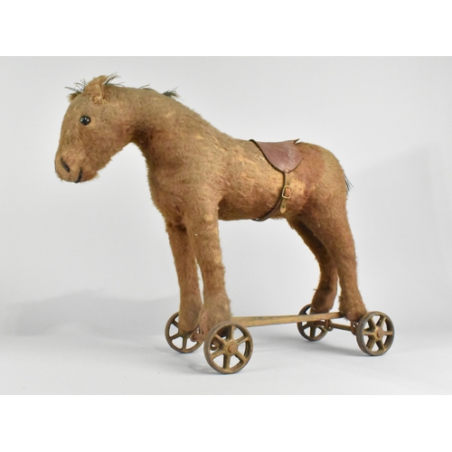 An Early 20th Century Pull-along Mohair Toy Donkey, Mounted on Iron Six ...