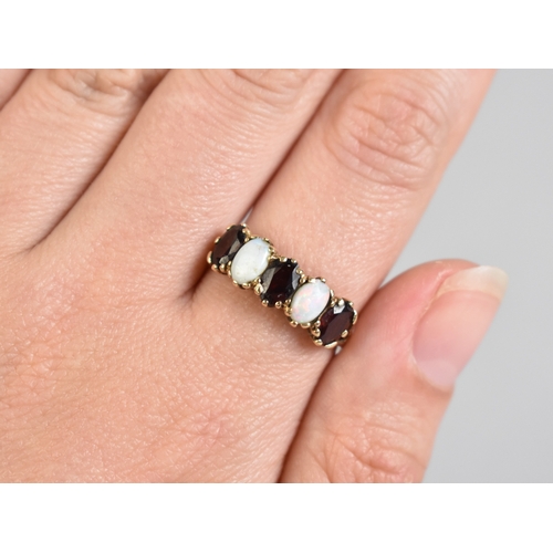 9 - A 9ct Gold, Opal and Garnet Mounted Five Stone Ring, Cabochon Opals and Oval Cut Garnets Mounted in ... 