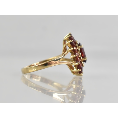 16 - A 9ct Gold and Garnet Set Dress Ring, Central Oval Cut Stone Measuring 7.7mm by 5.7mm Supported in F... 