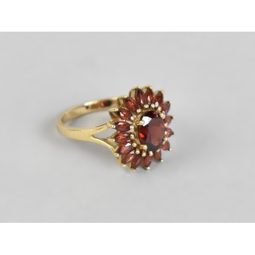 16 - A 9ct Gold and Garnet Set Dress Ring, Central Oval Cut Stone Measuring 7.7mm by 5.7mm Supported in F... 