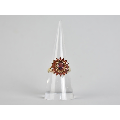 16 - A 9ct Gold and Garnet Set Dress Ring, Central Oval Cut Stone Measuring 7.7mm by 5.7mm Supported in F... 
