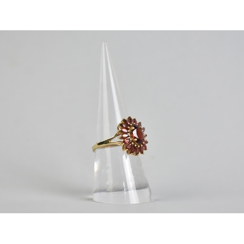 16 - A 9ct Gold and Garnet Set Dress Ring, Central Oval Cut Stone Measuring 7.7mm by 5.7mm Supported in F... 