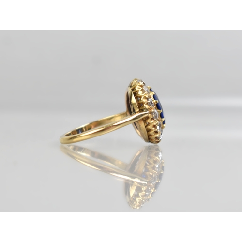 30 - An Impressive Vivid Blue Garnet Topped Doublet and Diamond Ring, Central Mixed Oval Cut Stone Measur... 