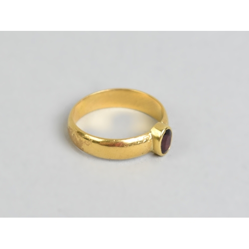 34 - A Gold Metal Ring with Central Mixed Oval Cut Almandine-Pyrope Garnet, Bezel Set and Measuring 5.4mm... 