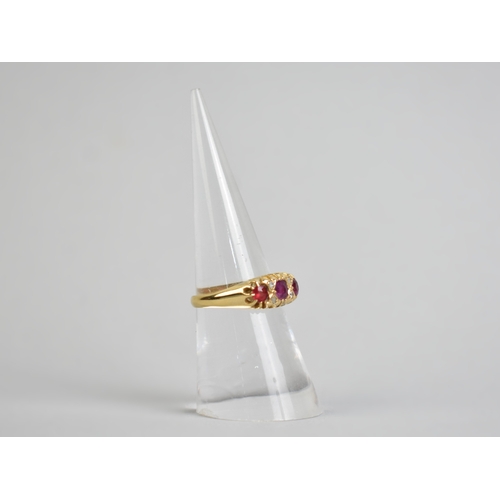 35 - A Ruby and Diamond Boat Shape Ring (One Coloured Side Stone is Replacement Paste), Central Mixed Cus... 