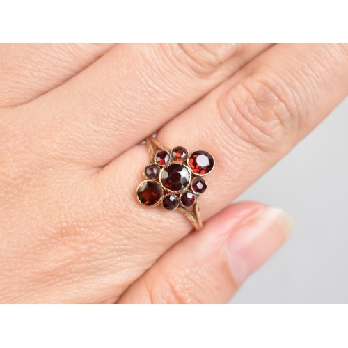 12 - An Antique Almandine-Pyrope Garnet Cluster Ring in Unmarked Gold Coloured Metal, Three Mixed Round C... 