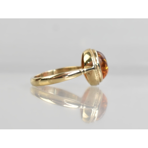 46 - A 9ct Gold and Amber Cabochon Ring, Bezel Set and with a Rope Twist Frame to Tapered Shoulders and a... 