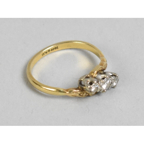 52 - An 18ct Gold and Platinum Mounted Diamond Trilogy Ring, Primary Round Cut Stone Set in Ten Claws and... 