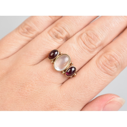 55 - An Antique Style Moonstone and Almandine-Pyrope Garnet Ring, Bezel Set Central Moonstone Cabochon Me... 