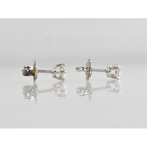 57 - A Pair of Diamond and White Metal Stud Earrings, Each Stone Measuring 4.1mm Diameter Approx, Support... 